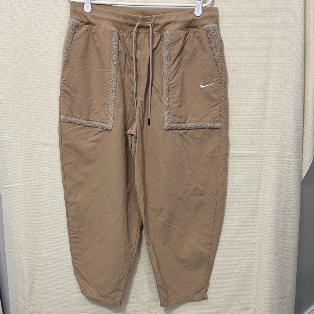 Nike High Wasted Jogger Pants with Sherpa lined pockets and trim.